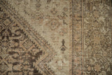 Distressed antique Hamadan carpet pile, revealing the muted Herati pattern and visible foundation.