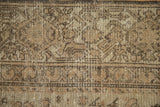 Distressed antique Hamadan rug detail with worn pile, exposed foundation, Samovar turtle border.