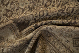 Distressed antique Hamadan rug's texture, revealing worn pile, exposed foundation, soft earthen patterns.