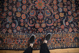 Navy blue field vintage Dargezine carpet with brick red floral arabesques and border design.