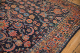 Vintage Persian Dargezine carpet detail: rich navy field, brick red border, floral arabesques.