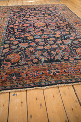 Close-up of Vintage Dargezine rug border with faded brick red floral motifs and fringe.