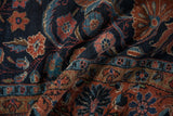 Detail of hand-knotted Dargezine carpet: navy, brick red, powder blue floral arabesques.