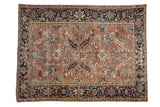 Vintage Persian Mehrivan carpet with dusty blush field, navy border, and geometric floral design.