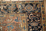 Vintage Mehrivan carpet showing an ornate dusty blush field and navy blue Herati border with serpents.