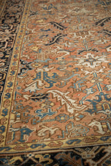 Vintage Mehrivan carpet pile with dusty blush field, scrolled serrated leaves, and navy border.