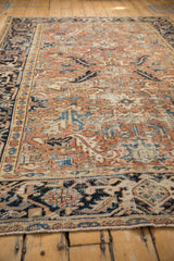 Vintage Mehrivan rug close-up: textural pile with geometric floral and leaf motifs in muted blush and blue.