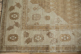 Floral and finned fern leaf border motifs in pale coffee brown and sand tones.