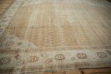 Angled view of a distressed Kars carpet's low pile, showing sand and beige color variations.