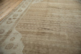 Angled view across the vintage Kars carpet, highlighting the short pile and textural sand-colored abrashes.
