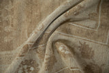 The supple texture and short, even pile of a distressed vintage rug in sand and beige.
