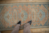 Distressed texture and geometric floral cross section medallions on the Hamadan runner.