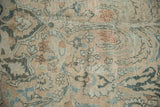 Distressed vintage Khorassan rug showing delicate vines, blossoms in dusty teal, sand.