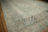 Distressed Khorassan carpet, faded beige and teal, featuring serrated leaf main border.