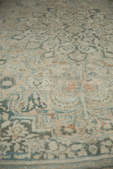 Distressed vintage Khorassan rug's delicate floral arabesques in faded beige, teal, and copper.
