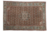 Antique Persian Malayer rug with a starburst medallion on a rust red field and a slate blue turtle Samovar border.