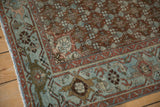 Corner detail of a distressed Malayer rug with a slate blue turtle Samovar border.