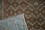 Corner detail of an antique Malayer rug showing its hand-knotted foundation and side selvage.