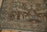 Corner view of a vintage Hamadan rug highlighting the geometric border and evenly worn pile texture.