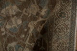 Hand-knotted texture showing mostly even wear to the pile in brown and faded blue tones.