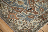 Distressed Hamadan rug corner, highlighting samovar turtle border and geometric motifs.