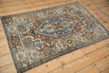Distressed Hamadan rug detail: samovar turtle border, geometric floral field in blue, copper, chestnut.