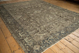 Distressed vintage Mehrivan carpet field, showcasing faded floral motifs and textured pile wear.