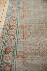 Distressed texture of the antique Malayer runner, with worn lattice field and faded pomegranate border.