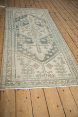 Close-up of distressed Hamadan runner with softened texture, primitive motifs in dusty blue and ivory.