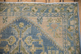 Distressed Hamadan rug detail: faded blue, ivory, green, gold serrated leaves and pearl border.