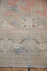 Distressed Veece carpet border showcasing faded cantaloupe, denim blue, beige tones, and fringe.