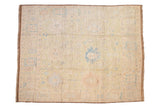 Distressed Afghani Oushak carpet with faded beige, sky blue, and dusty rose floral palmettes.