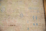 Distressed Afghani Oushak rug pile reveals pale blue, green, ivory hues, and shaded foundation.