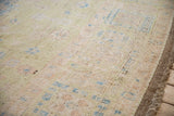 Distressed Oushak design carpet: sheared wool pile, blossoming tips, pale green, blue, and rose hues.