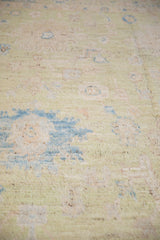 Distressed Afghani Oushak carpet's sheared texture in soft pale green, powder blue, and rose.