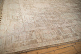 Distressed Afghani Oushak carpet showing soft long-stapled wool pile in ivory and beige.