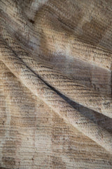 Close-up of hand-knotted carpet foundation, showing dark wefting between knots.