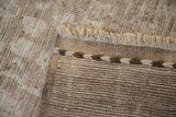 Textured foundation, two-tone braided selvage, and light fringe of Afghani Oushak rug.