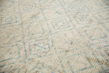Distressed Afghani Moroccan rug with textured ivory pile and powder blue trellis.