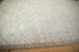 Distressed ivory pile with powder blue trellis pattern and original colorful side cord selvage.