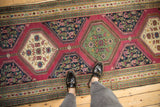 Intricate floral medallions in ivory and emerald green on an antique Karabagh runner.