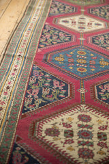 Close-up of antique Karabagh rug's ivory inverted medallion, sapphire blue henna motif.