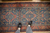 Intricate Herati design and serrated leaf border on antique Heriz runner in navy and red.