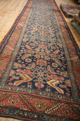 Antique Heriz runner showing floral Herati design in cobalt blue and madder root red from an angle.
