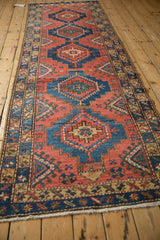 Distinctive repeating geometric stepped guls and border motifs in madder root red and sapphire blue.