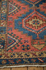 Vintage Northwest Persian runner: geometric stepped guls in madder red, sapphire blue, and beige.