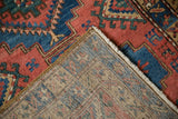 Northwest Persian runner's hand-knotted foundation, showing blue, red weave, and fringed corner.