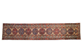Vintage Persian Serab runner with a column of geometric medallions in alternating sapphire blue and red.