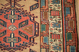 Detail of the dense wool pile on a vintage Serab rug's geometric border and medallion.