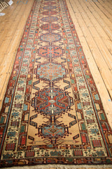 A long perspective view of a vintage Persian Serab runner with its repeating single-column medallions.